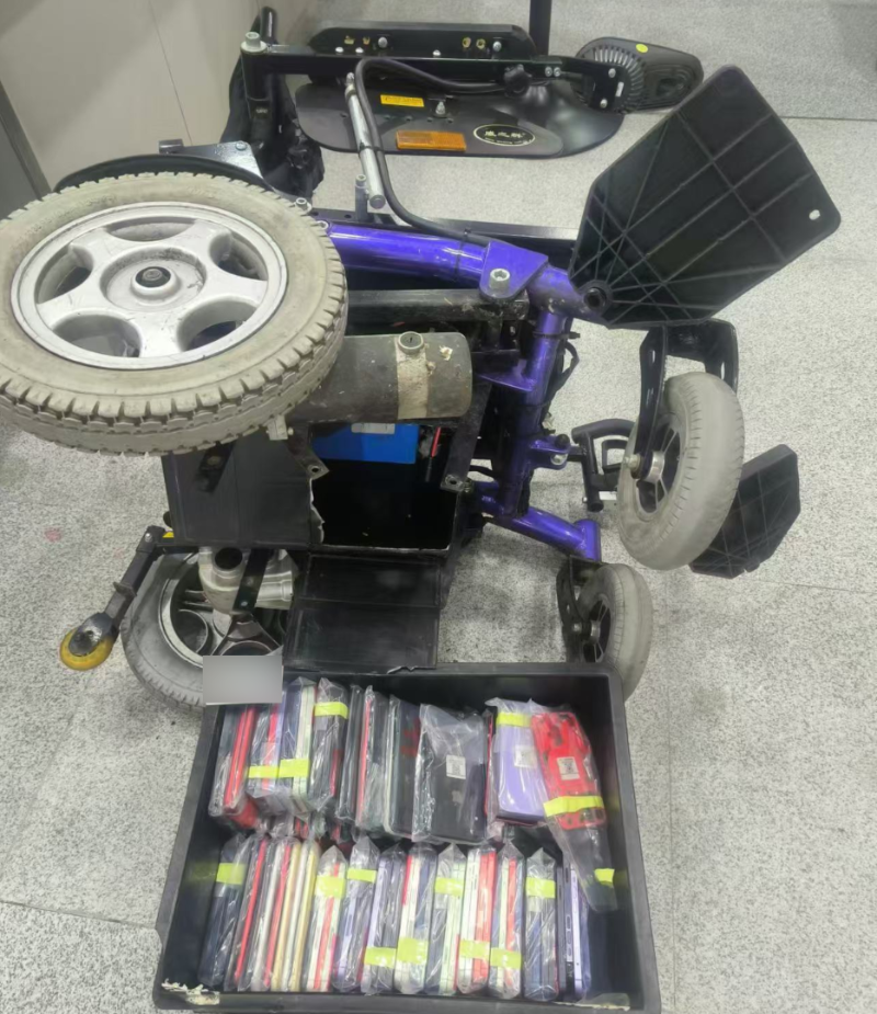 Hải quan Trung Quốc thấy người đàn ông đi xe lăn dáng vẻ kỳ lạ, lục soát ra có tới 97 chiếc điện thoại - Ảnh 1