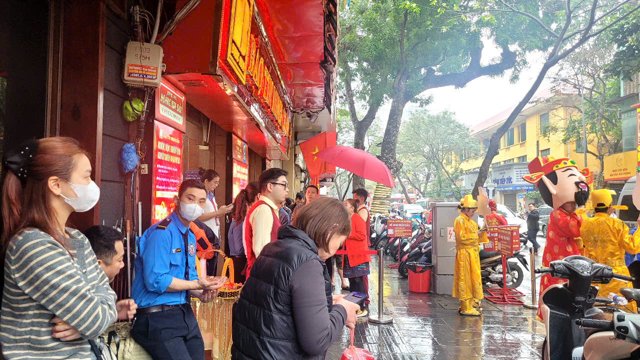 Người dân đội mưa xếp hàng chờ mua vàng trước ngày vía Thần Tài - Ảnh 1